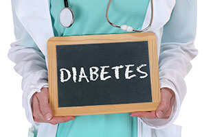 Doctor hold a chalk board stating Diabetes