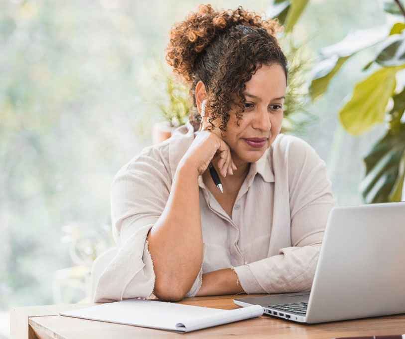 Woman working on a laptop.