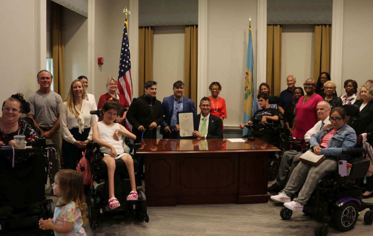Group of people attending the proclamation event to mark the 35th anniversary of the Americans with Disabilities Act (ADA).