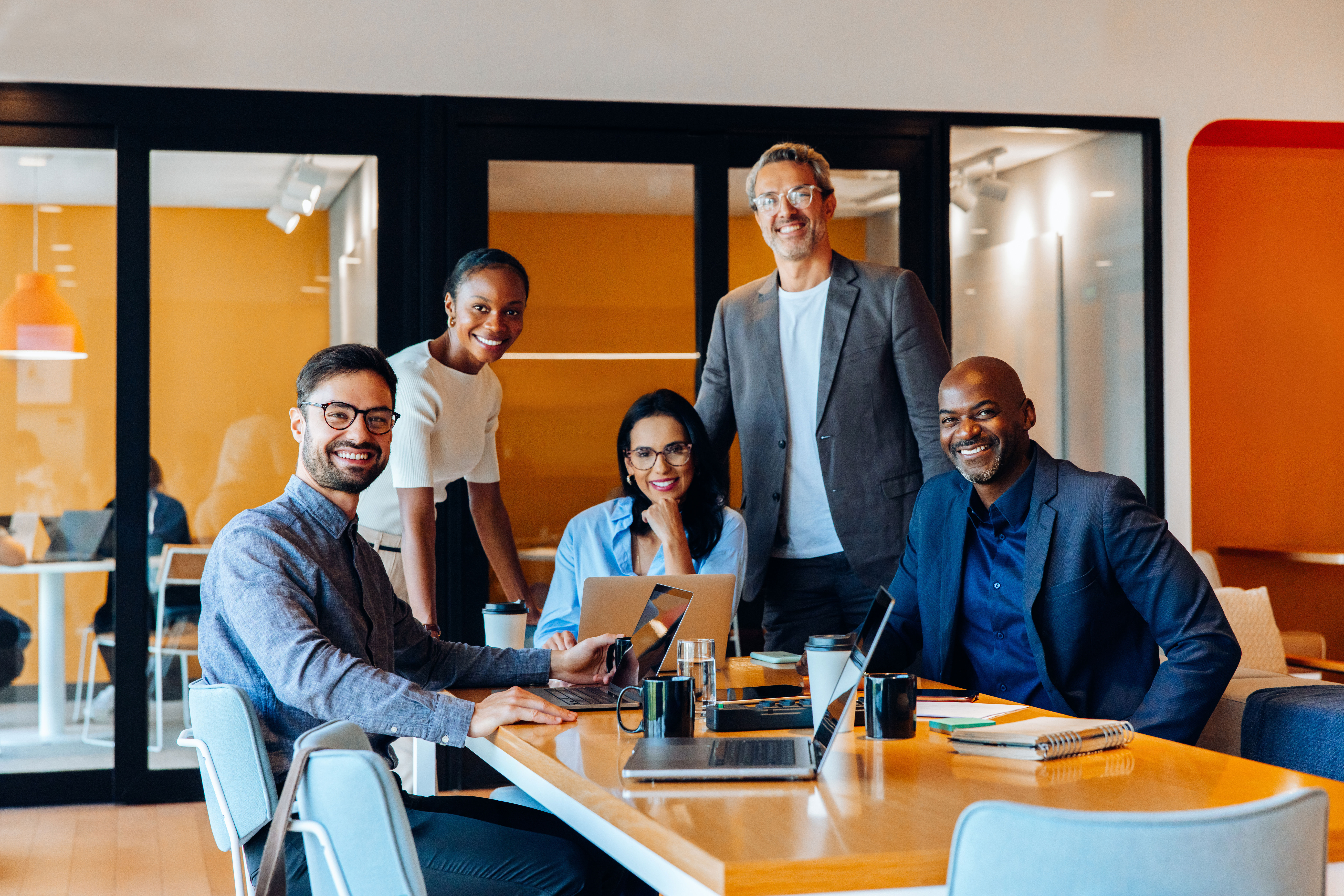 A group of diverse professionals working at a conference table