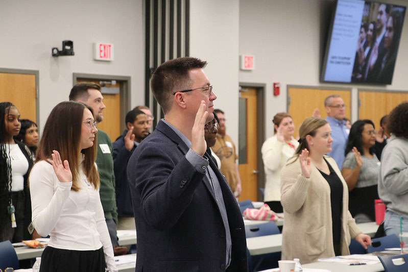 A group of new employess taking the Oath to Support the Constitution at the Statewide New Employee Orientation.