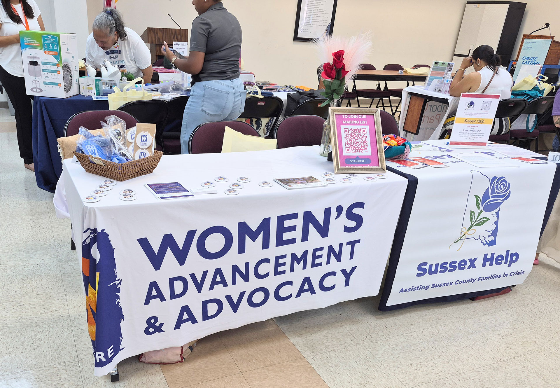 A group of tables at the Affordable Futures event highlighting the Office of Women's Advancement and Advocacy (OWAA) and Sussex Help.