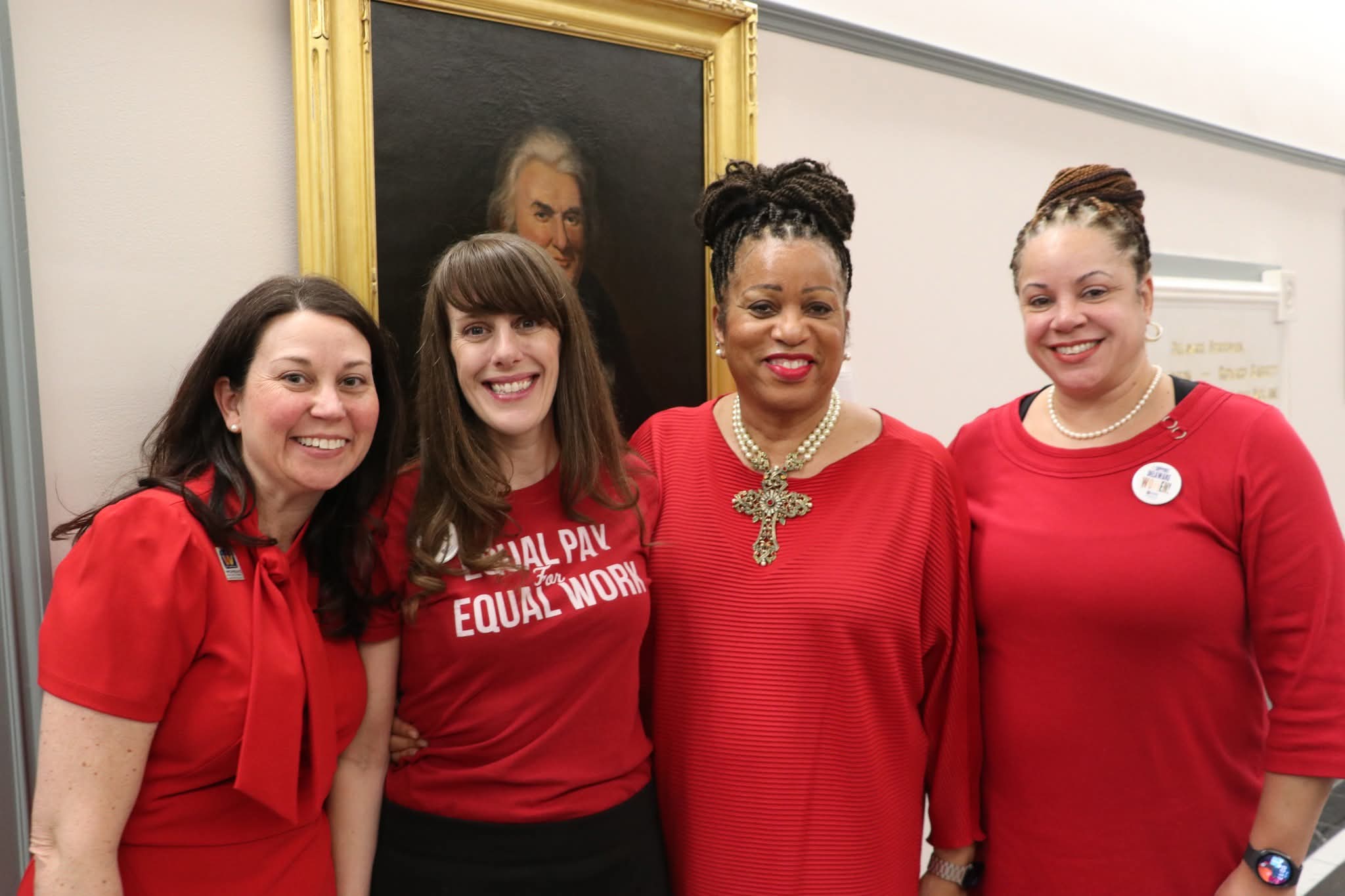 The Office of Woment's Advancement and Advocacy staff all wearing red for Equity Day at Legislative Hall.