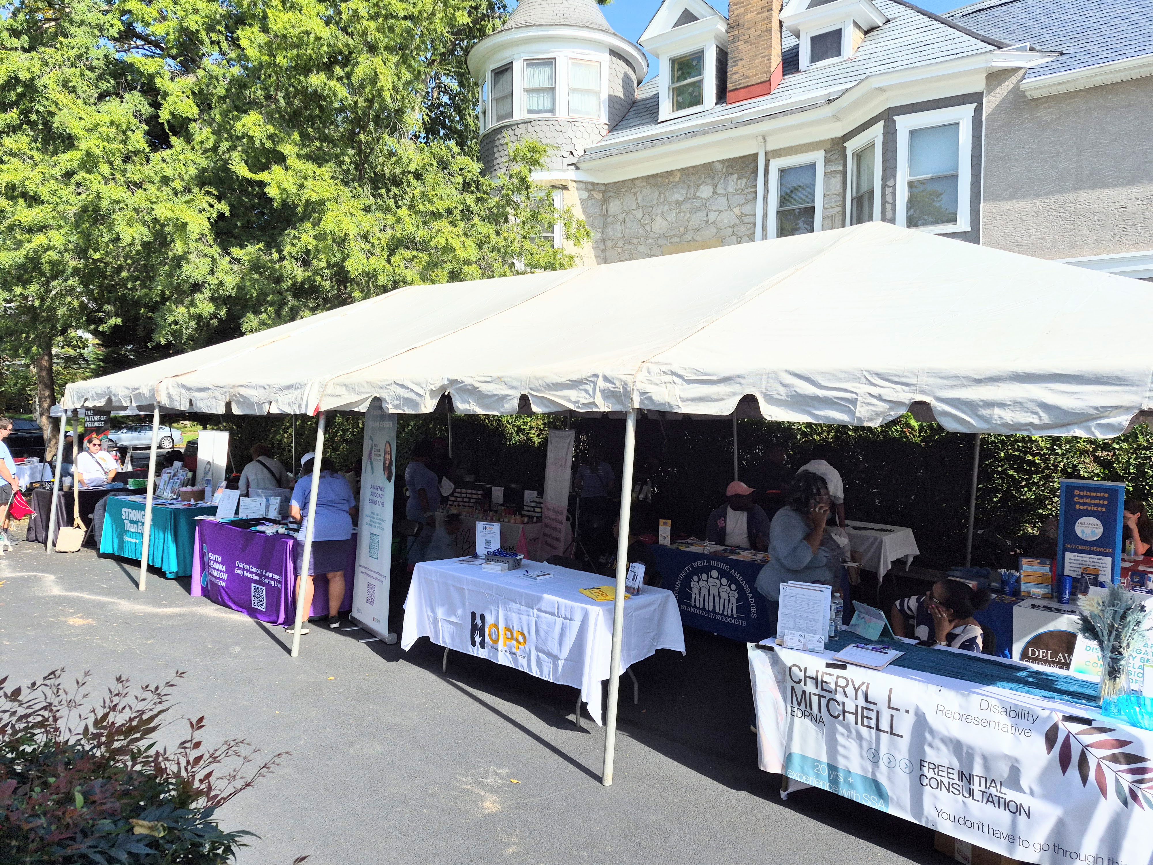 Showcasing outside vendors under a tent at the Health Equity Coalition Community Health Expo event.