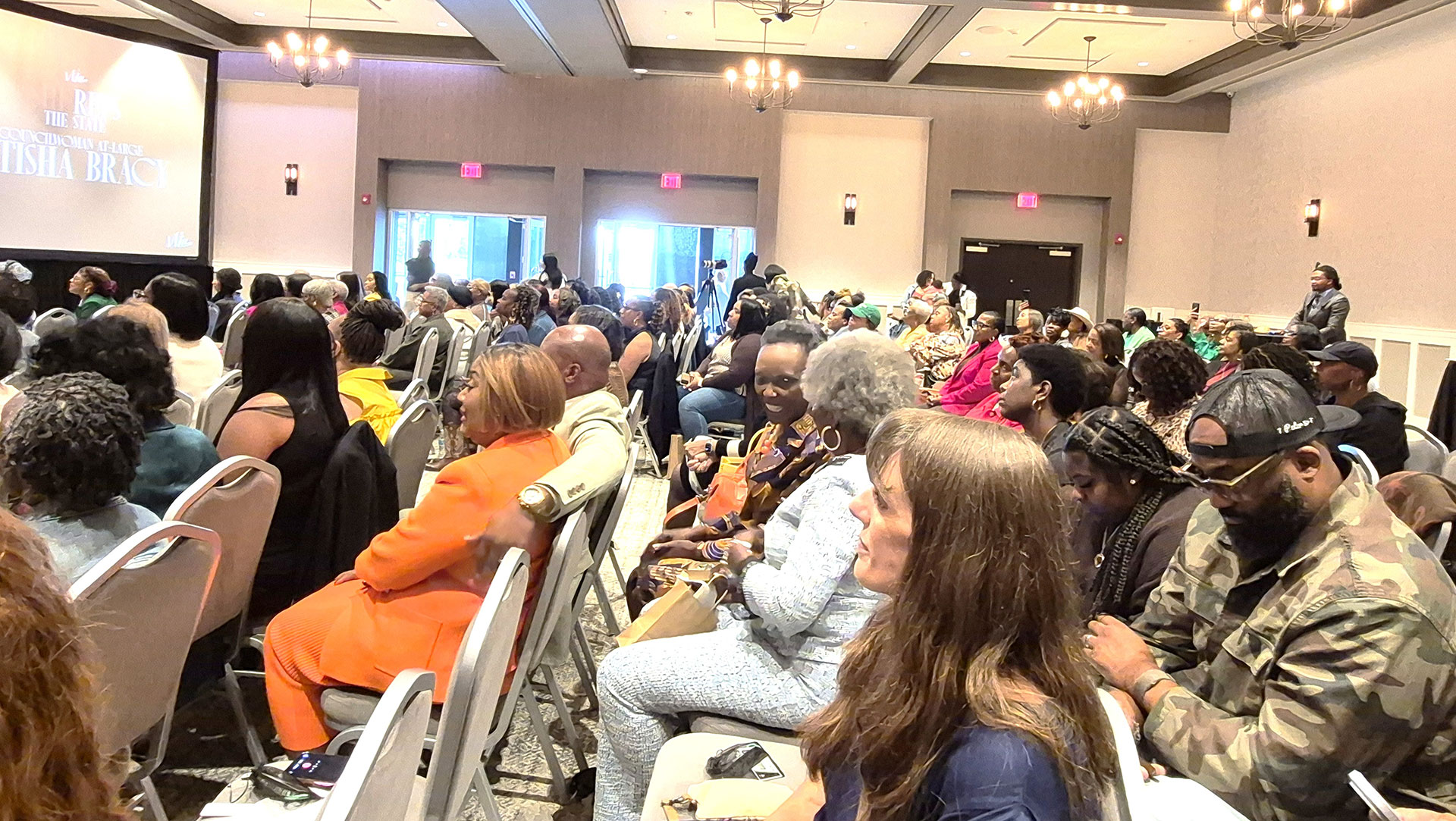 Room full of people participating at the Women of More Summit event.